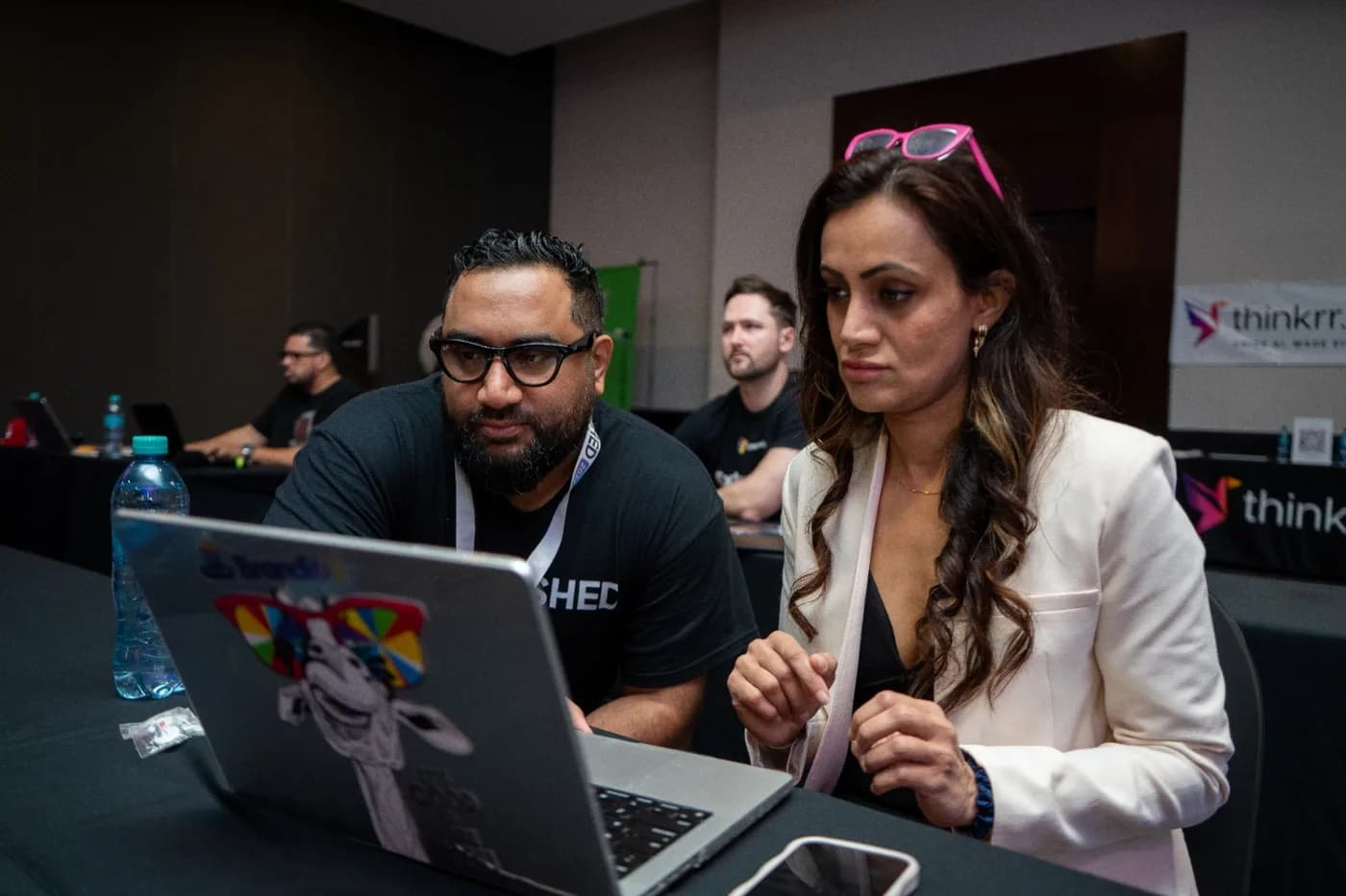 Two people working together at a laptop